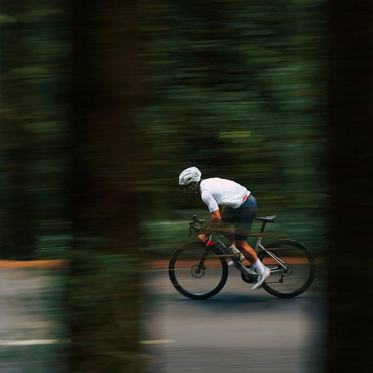 Cyclist riding fast through greenery